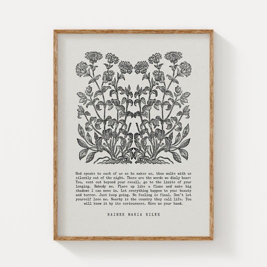 Botanical art print featuring a detailed black floral illustration paired with an excerpt from Rainer Maria Rilke’s writing, framed in natural wood and displayed on a white background for a timeless and literary aesthetic.