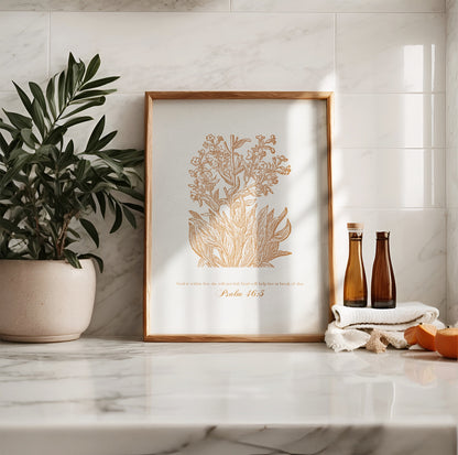 Golden floral botanical art print with Psalm 46:5, leaning on a marble countertop with decor elements like potted greenery and amber glass bottles.