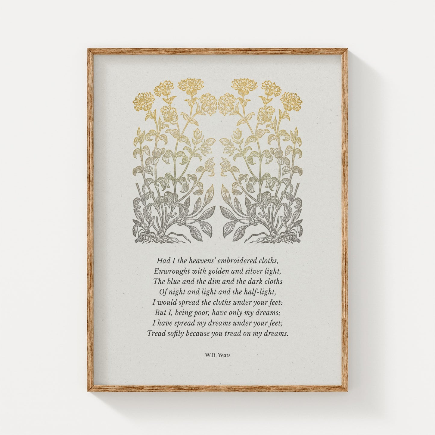 A vintage-style art print showcasing W.B. Yeats’ poem “He Wishes for the Cloths of Heaven,” adorned with elegant golden botanical illustrations, framed in natural wood against a neutral backdrop.
