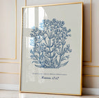 Romans 12:12 botanical print styled in an elegant gold frame, leaning against a cream wall with sunlight streaming through for a sophisticated look.