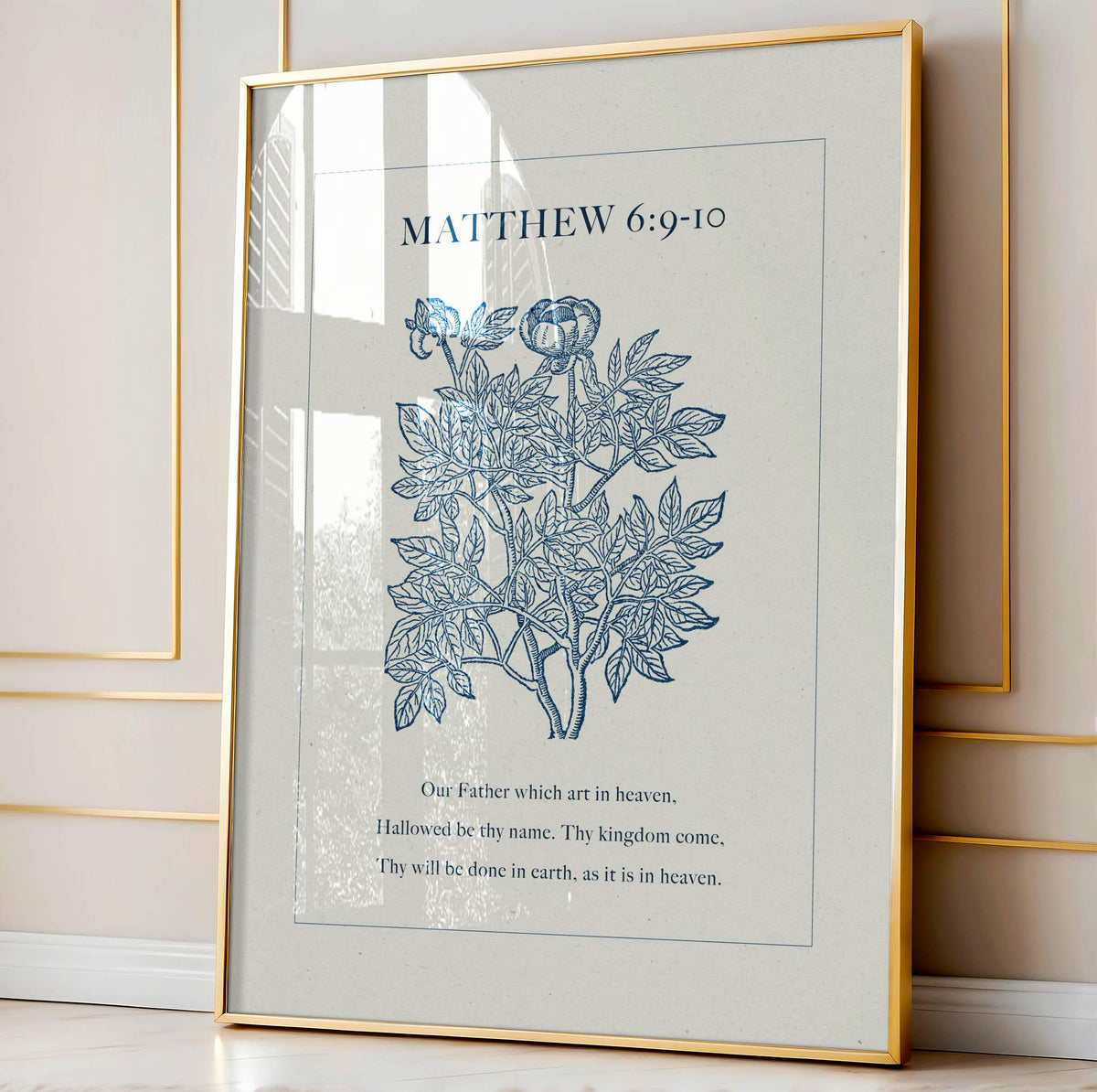 Framed artwork with floral design and Bible verse from Matthew 6:9-10 on a light background
